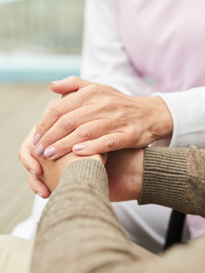 caregiver supporting patient holding hands