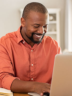 Happy mature man using laptop